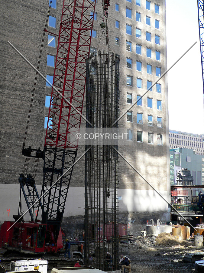 A rebar cage being lowered into a caisson hole