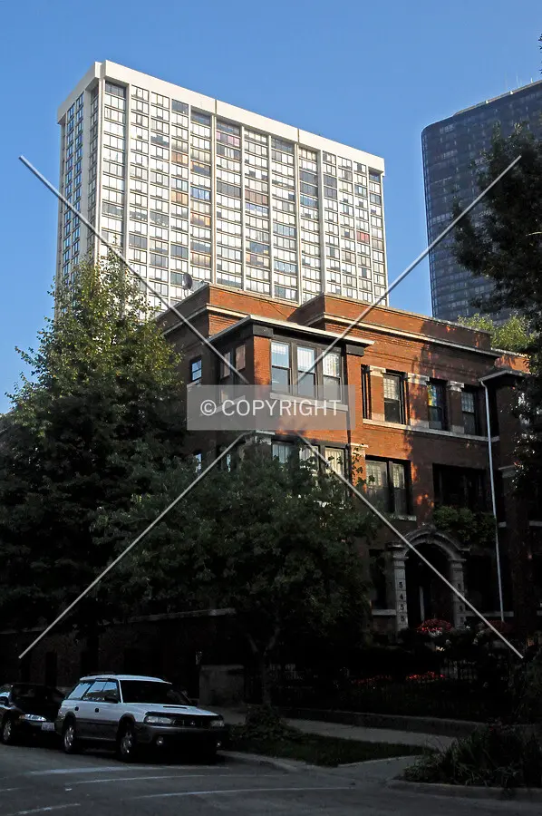 Contextual view with the upper floors rising above the surrounding low-rise neighborhood to the west