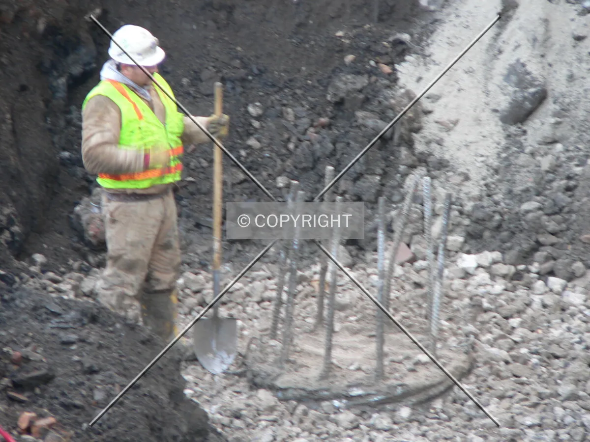 A worker unearthing a caisson