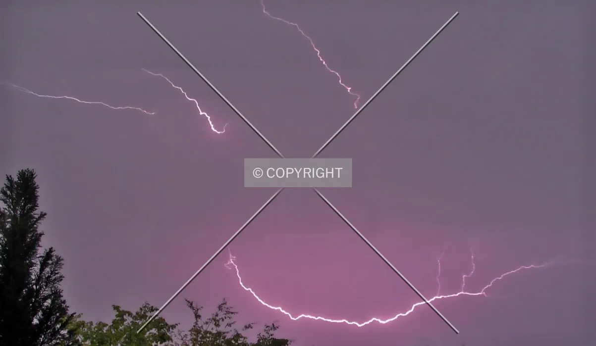 A flash of lightning during a thunderstorm looking like a smiley