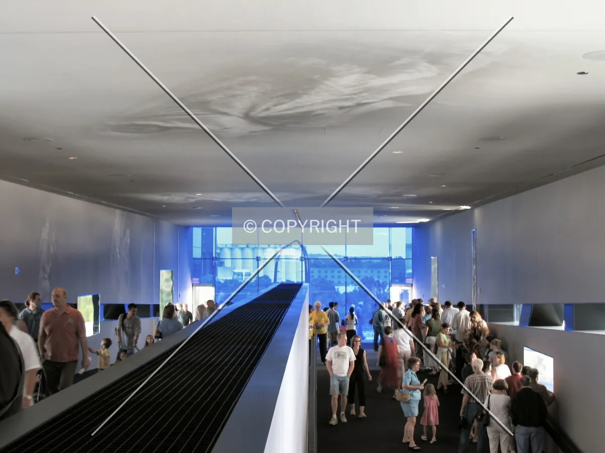 View toward the river from the Level 5 Lobby, ramp up from Level 4 on the right, blue glass framing views to Mississippi River