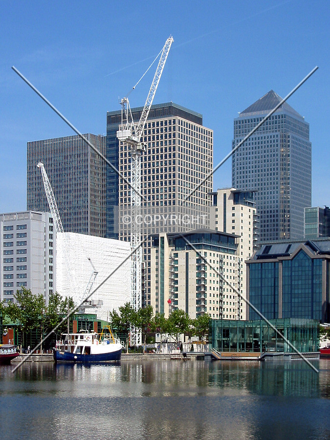 The cranes rising in front of Canary Wharf