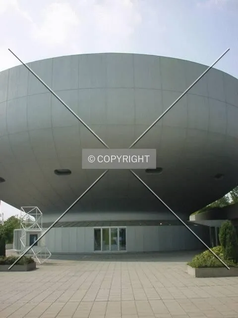Museum next to the main tower which has the company's logo painted ontop of its roof
