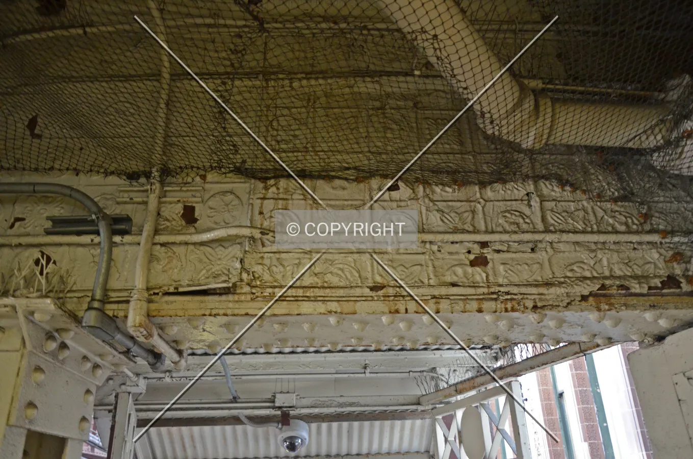 Decorative wall covering on the exterior of the old station house, forming a ceiling above the mezzanine; March 7, 2015.