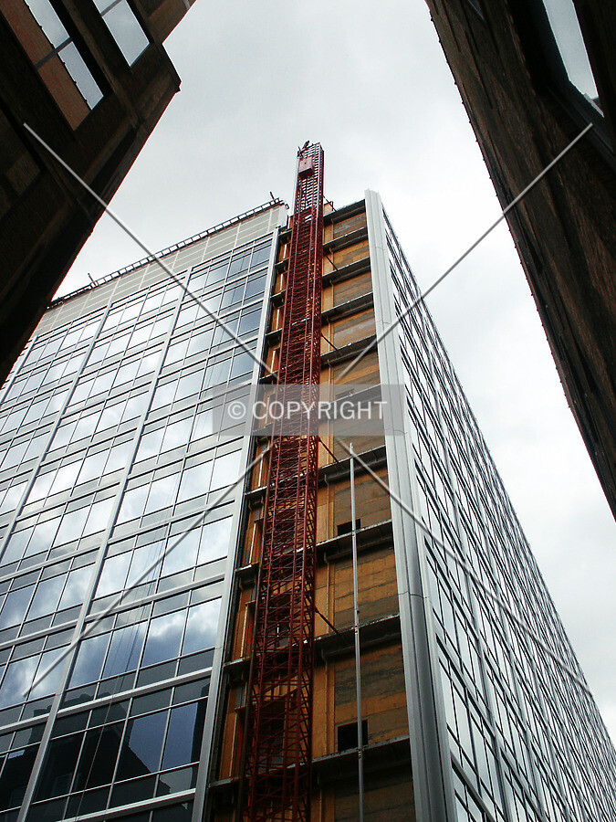 Looking up at the hoist from the alley