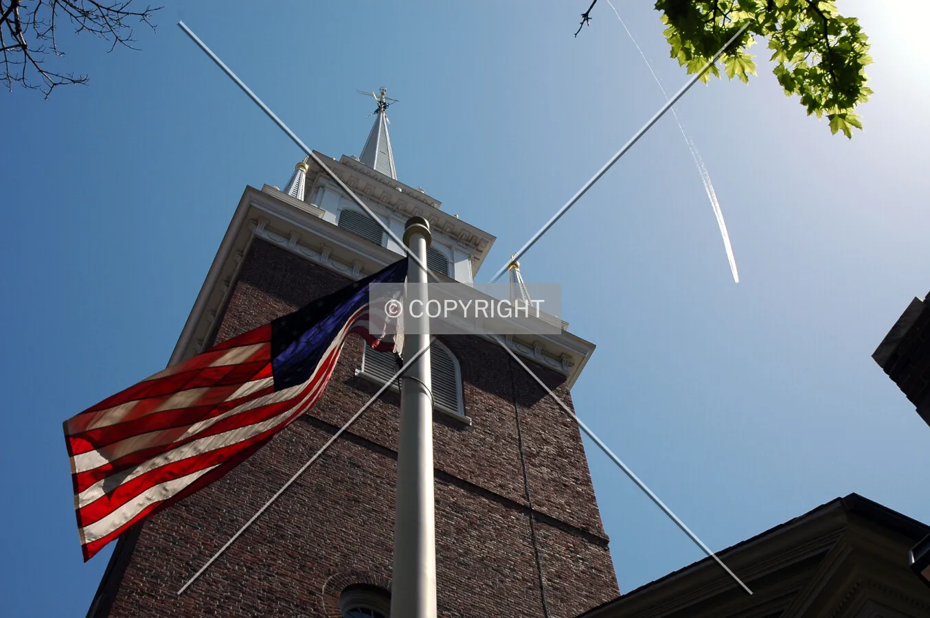The spire stands proudly above the Stars and Stripes
