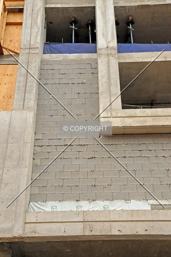 Infill wall made of concrete masonry block on the south side of the base