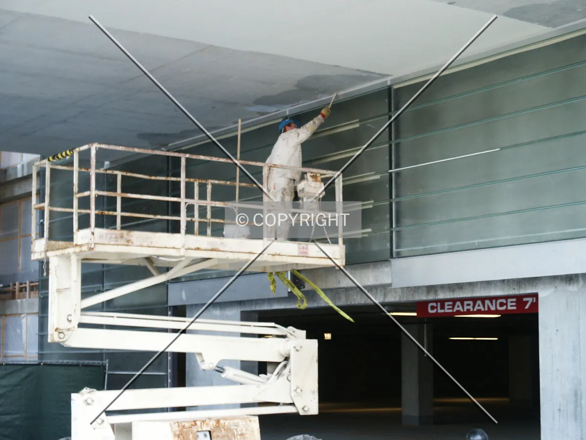 Painting the ceiling near Oak Tower's garage entrance
