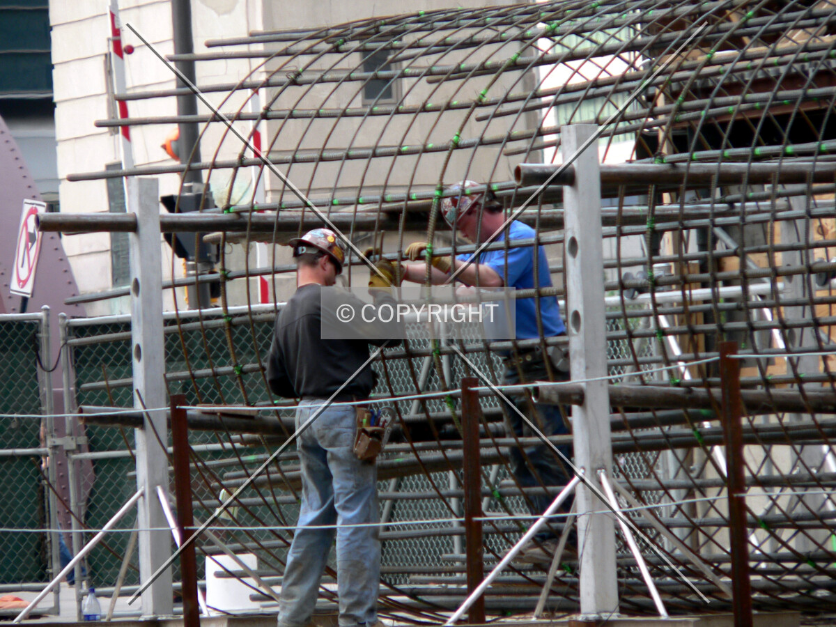 Workers assembling a rebar cage
