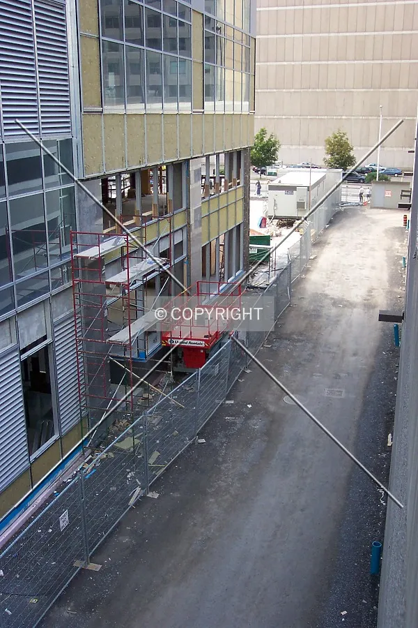 Looking down at the alley running along the east side of the tower, connecting the north courtyard to Laurier Avenue West