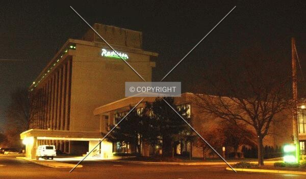 From the south at night, with the main entrance on the left and ballroom entrance on the right