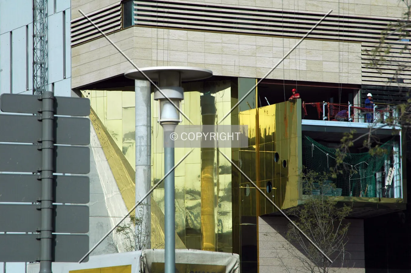 Installing gold metal facade on the building's entrance