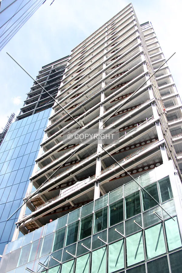 Looking up from Ropemaker Street showing façade installation progress to the south side