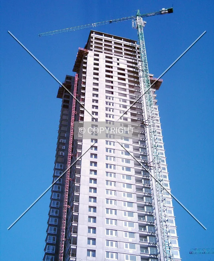 Cranes working almost in the final height of the building
