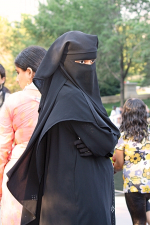 A woman watching children play