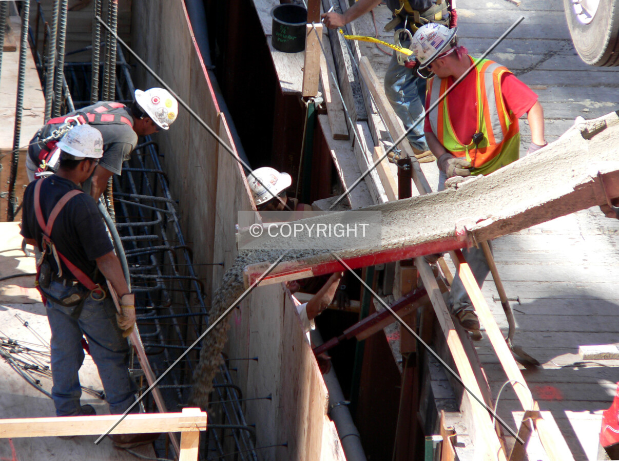 Dumping concrete to form the eastern lower level wall