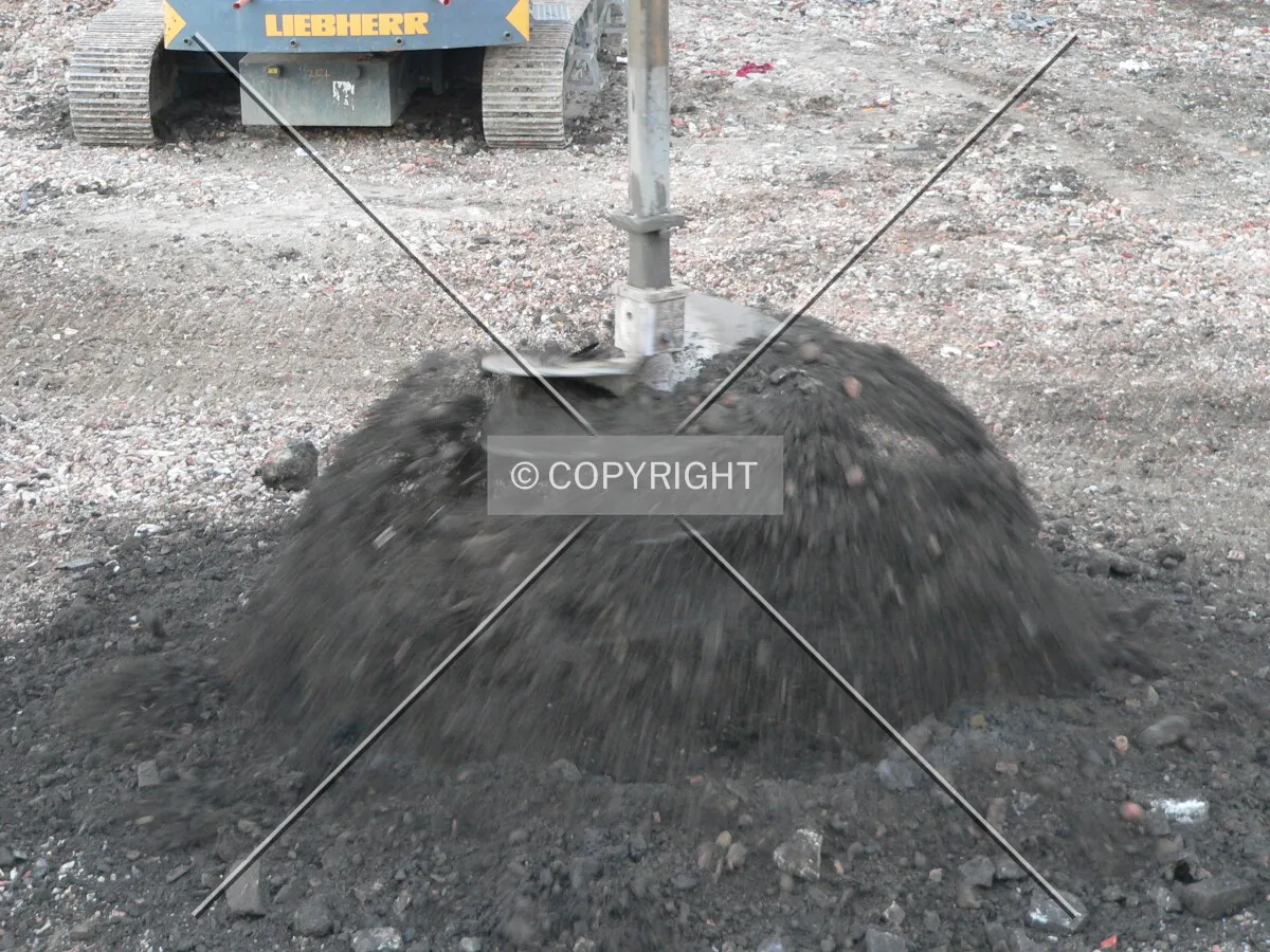 Spinning the dirt off of a caisson bit