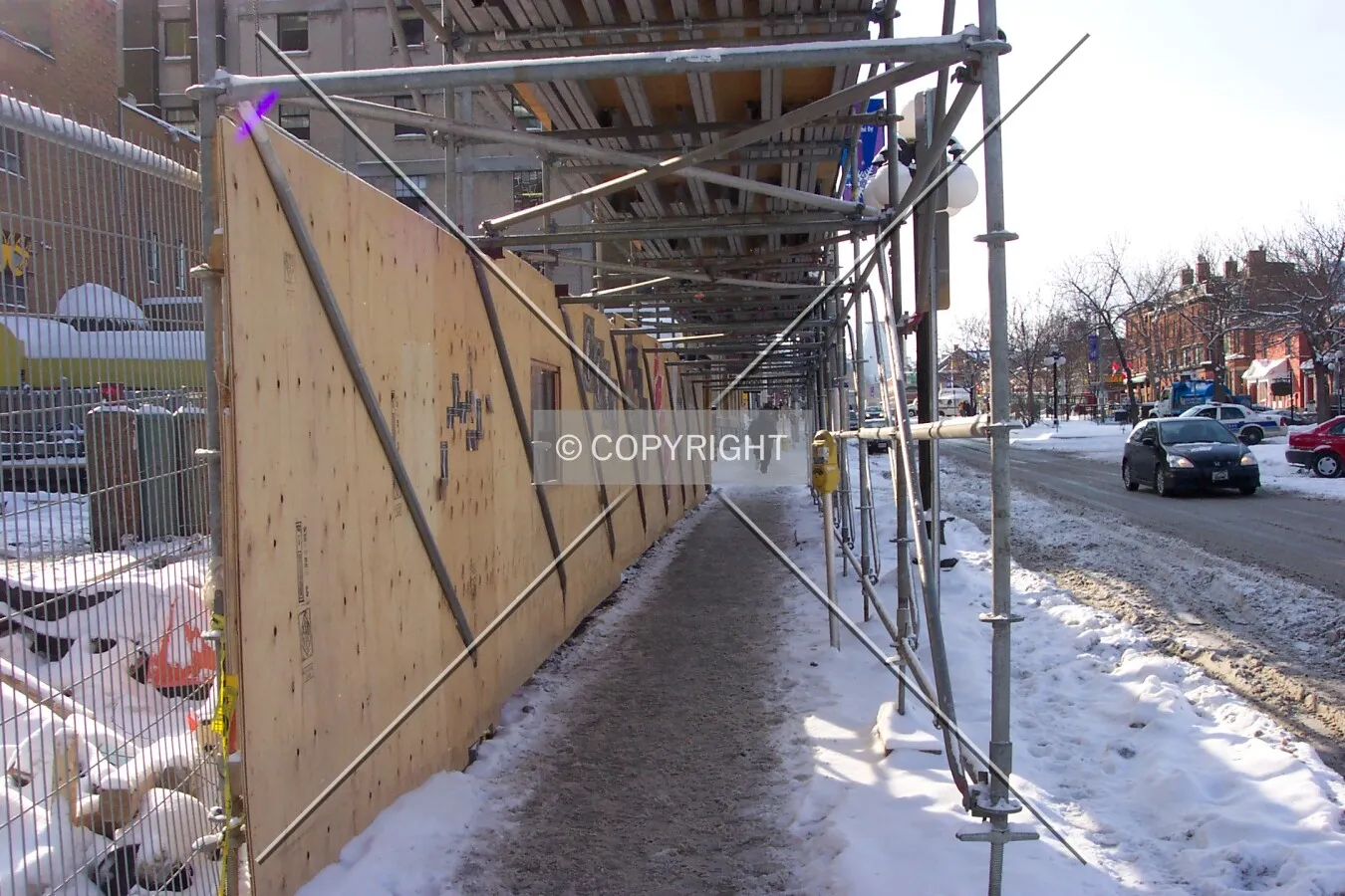 Protective scaffolding covering the pedestrian sidewalk