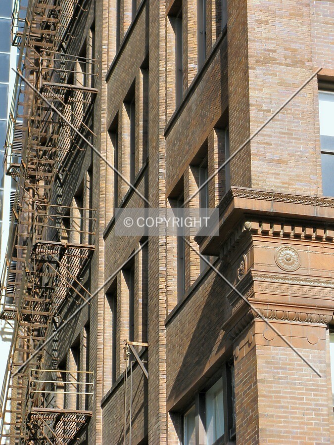 Southeast corner with fire escape stairs over the alley