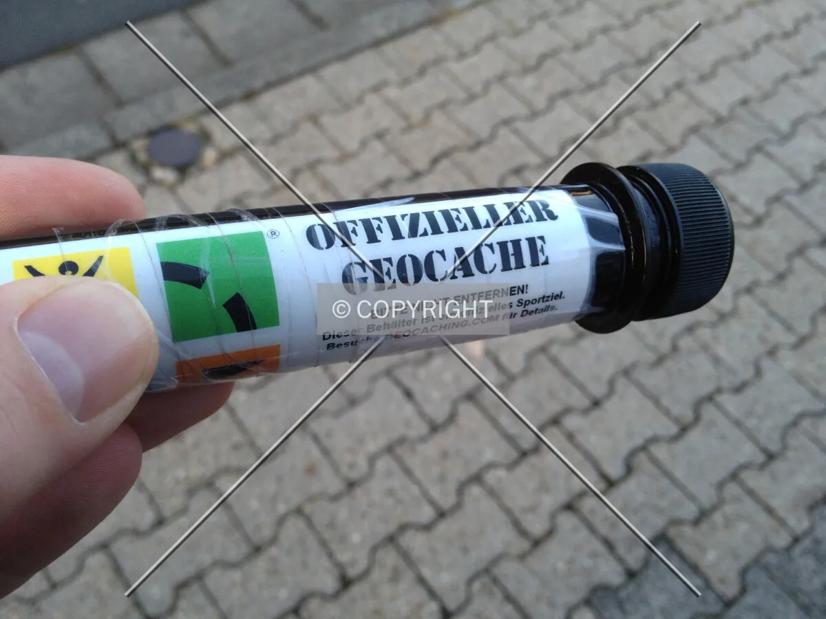 A container holding a geocache -- having German text on it