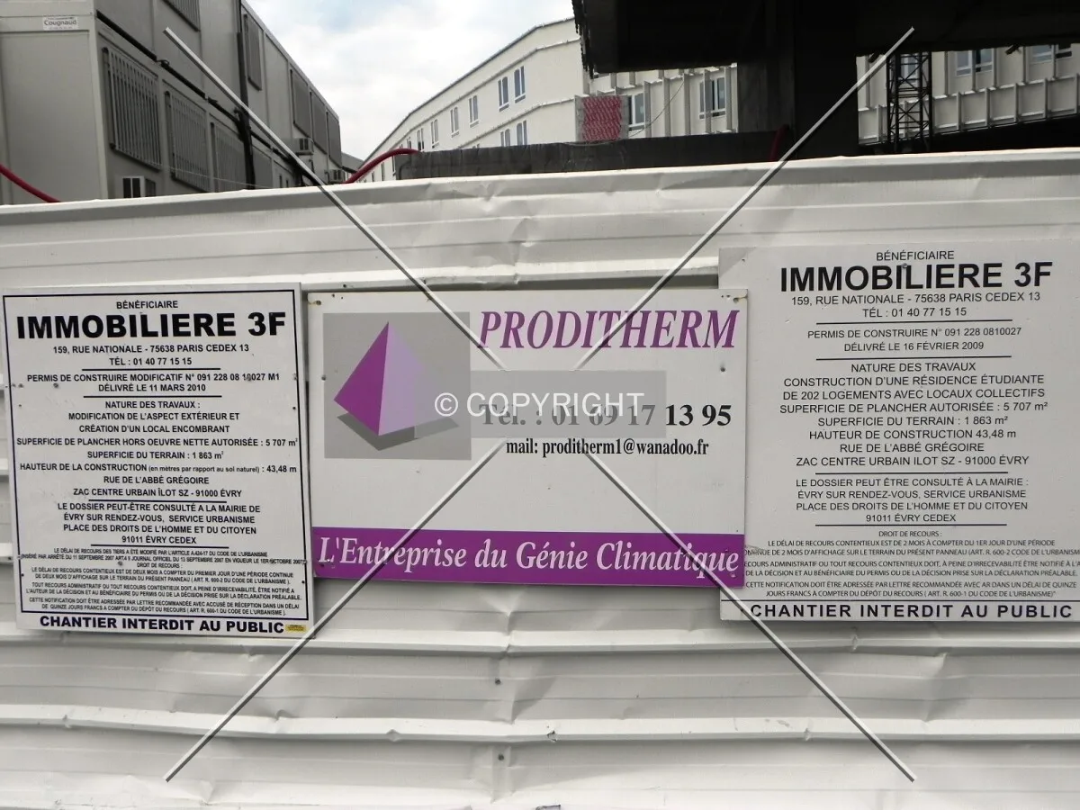 The building permit shown at the construction site.