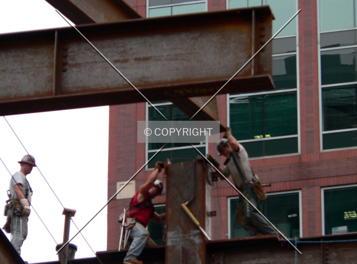 Workers placing a beam