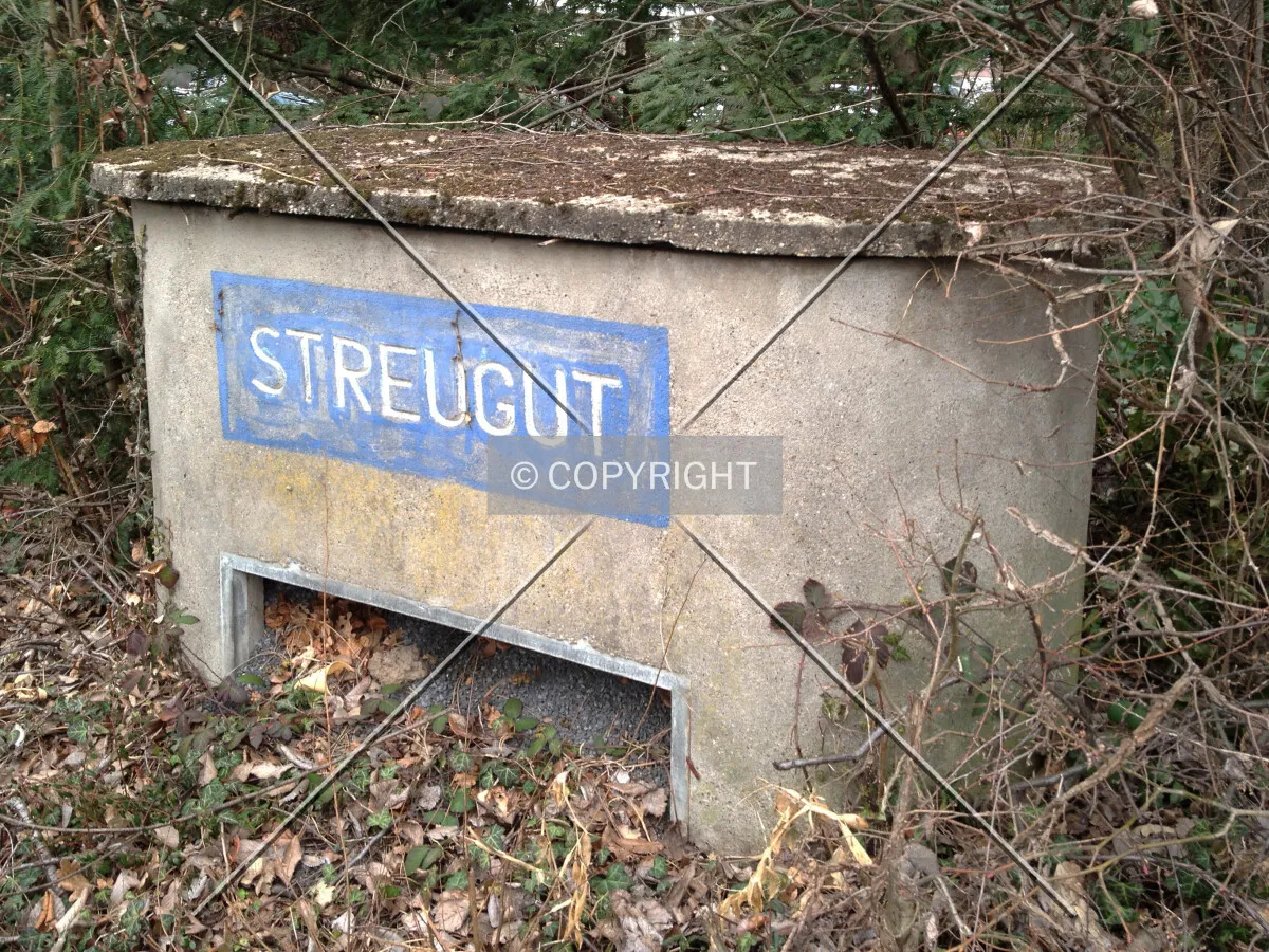 A container holding stone chips for icy streets