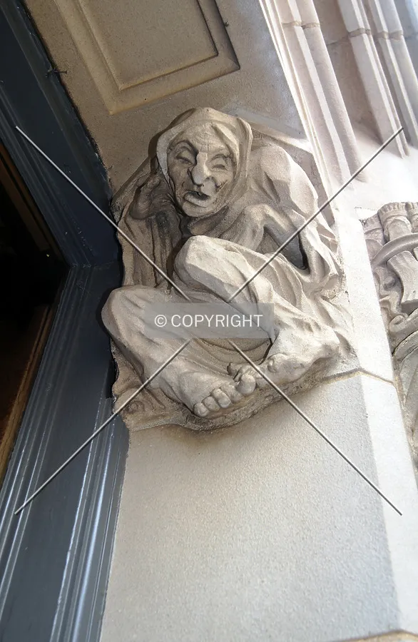 Looking up at ornamentation above the first floor windows