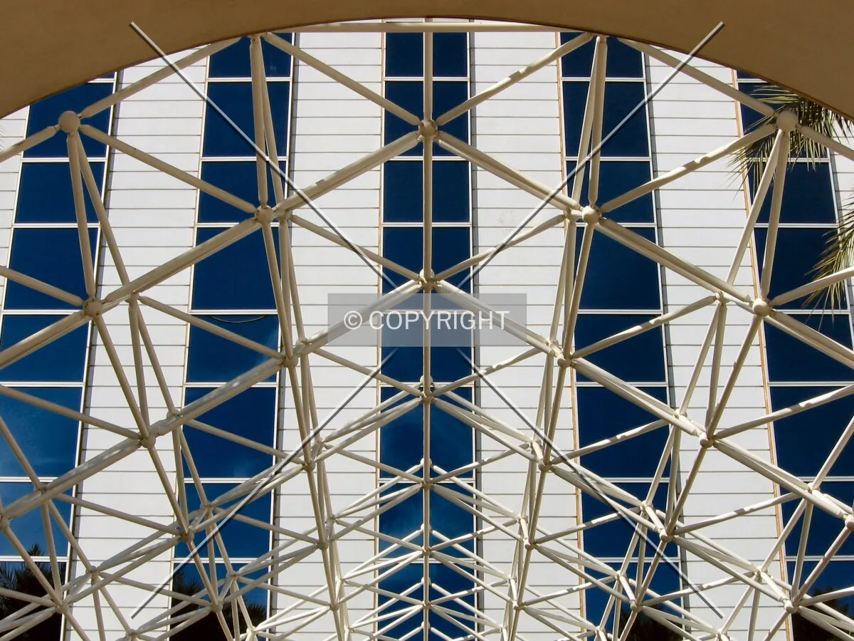 East facade through the skeletal entrance canopy