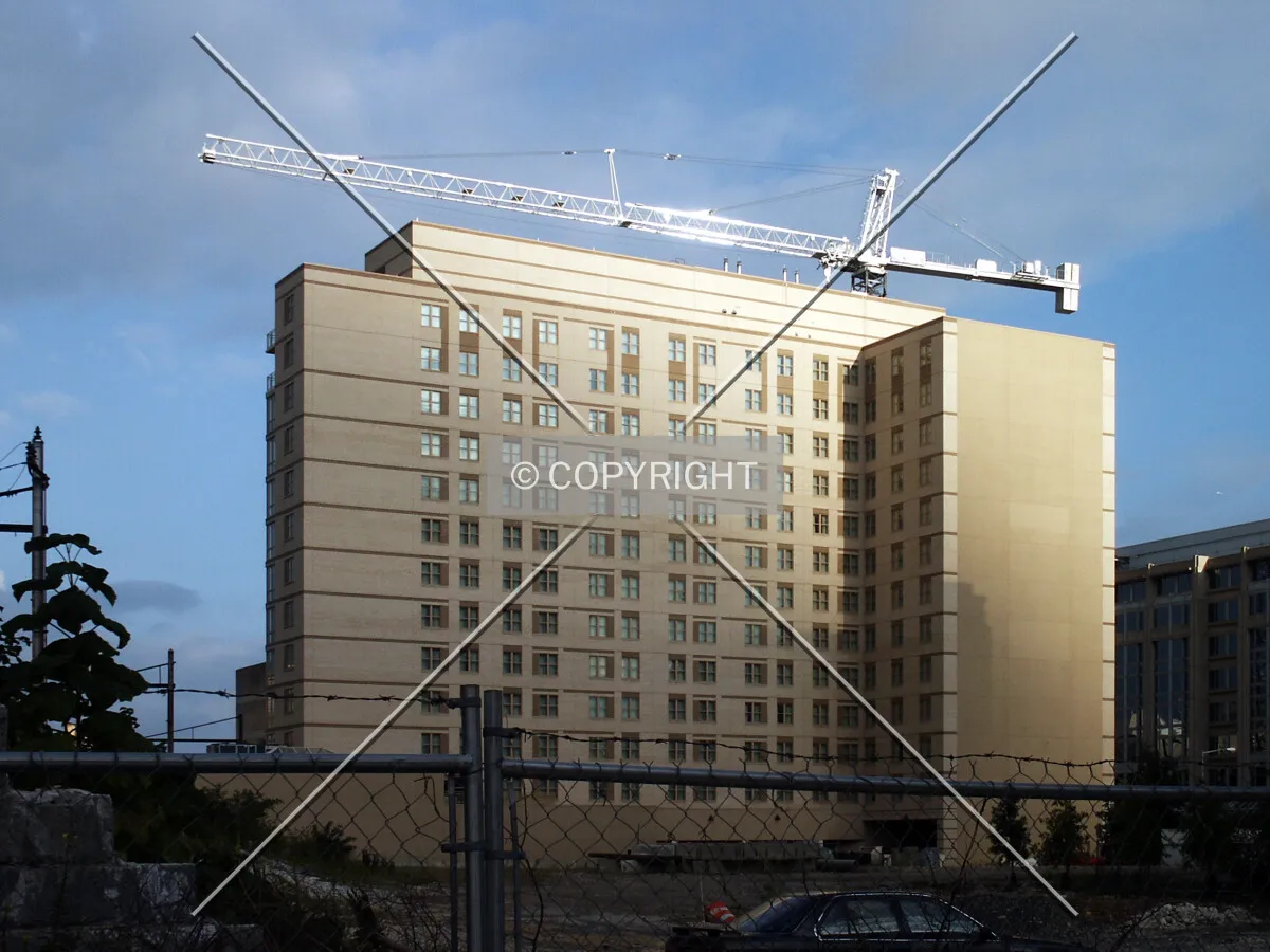 Tower crane rising over the hotel next door, seen from the west