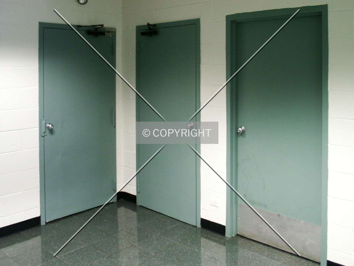 Doorways from the lobby to the basement, stairway, and bicycle room (left to right)