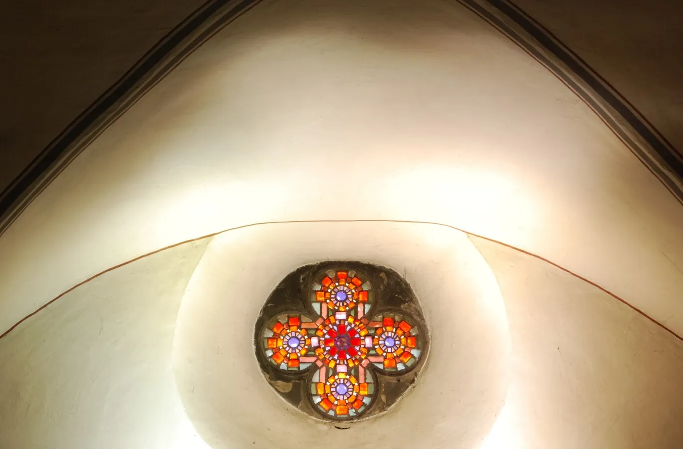 Small stained glass window above the main entrance