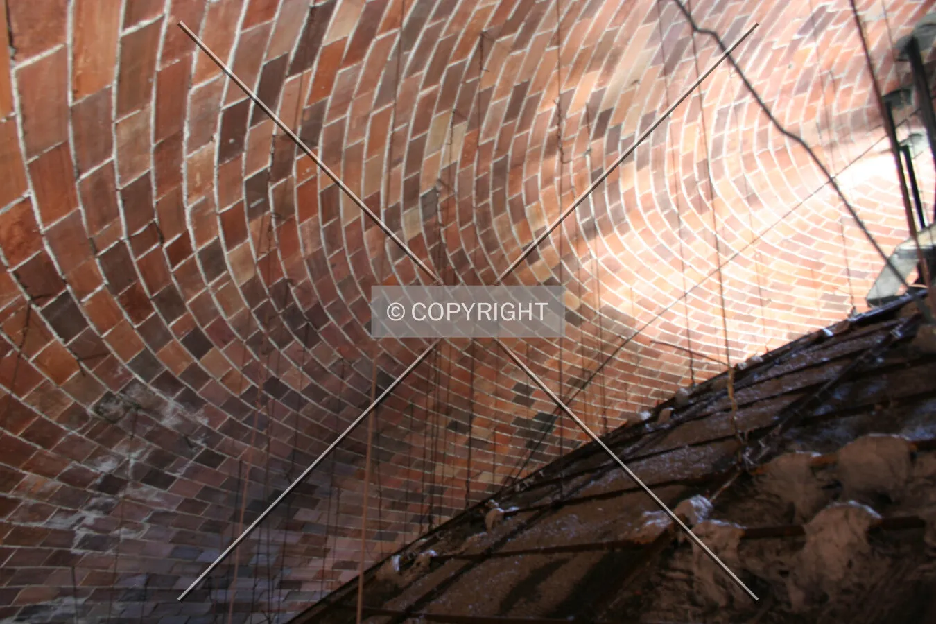 Between the inner and outer layers of the dome