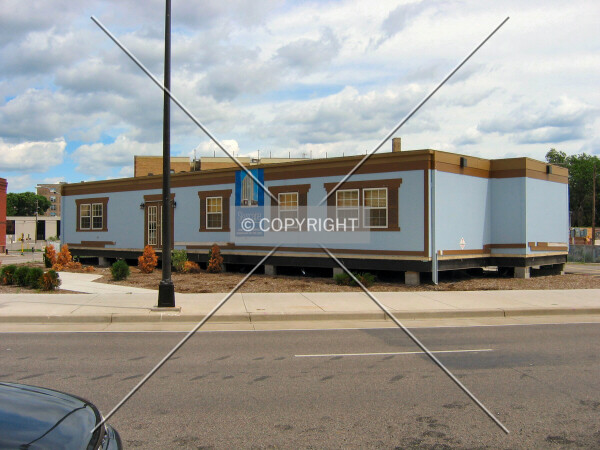 Partially-disassembled sales office from across 10th Street
