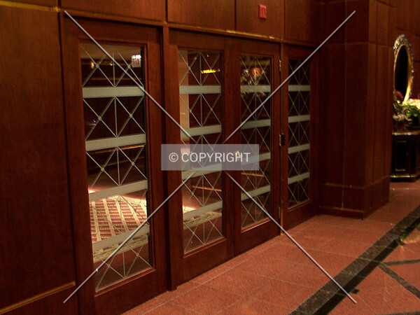 Glass doors between the lobby and elevators
