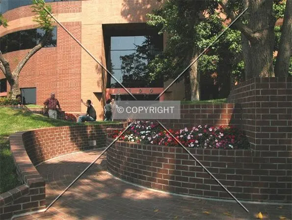 Workers take a break at the building's front entrance