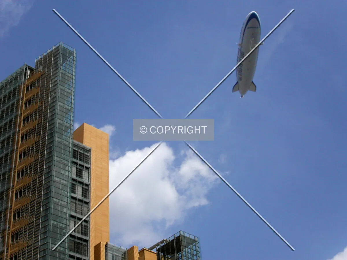 A zeppelin flying over the building