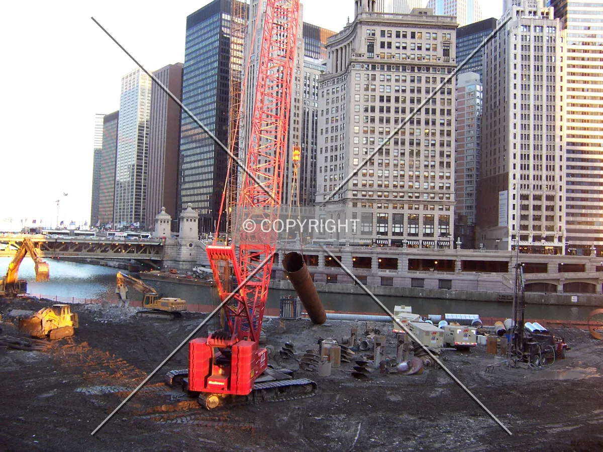 A crane begins to lift a permanent liner also (known as a “rock can”) for a rock caisson