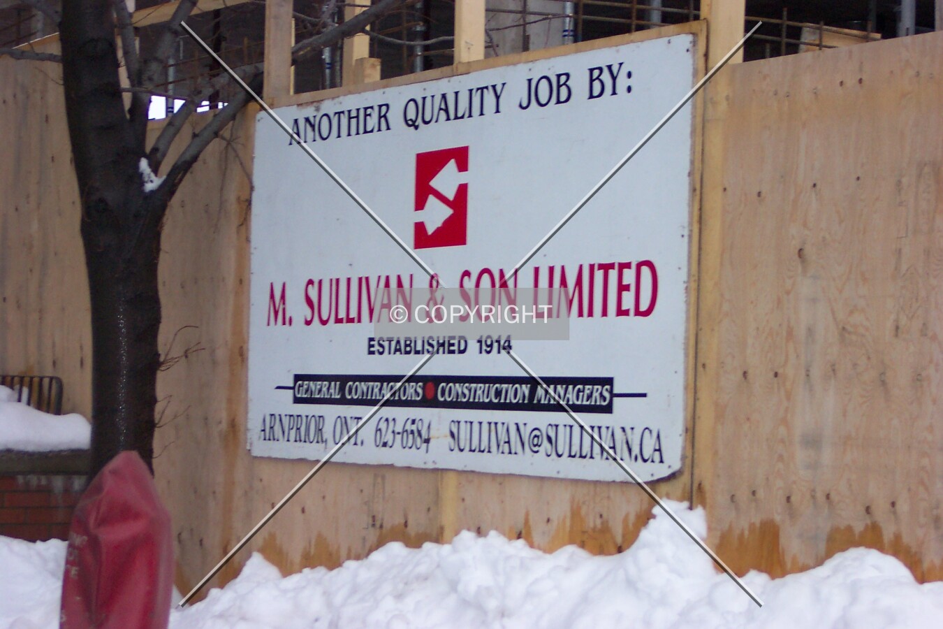 Sign for the construction company adorning the wall on the east side of the tower