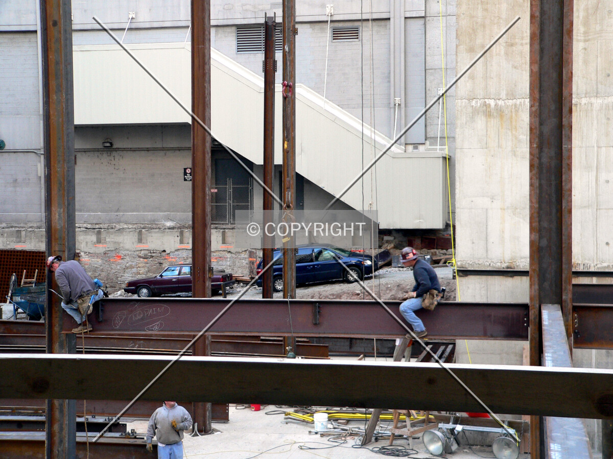 Ironworkers connecting steel beams