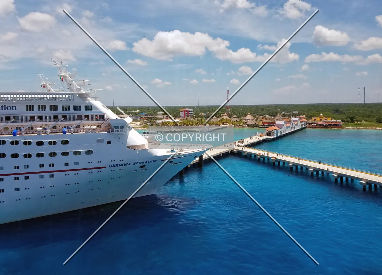 View across the pier from the Carnival Triumph cruise ship looking towards the southern Cozumel skyline; August 27, 2016