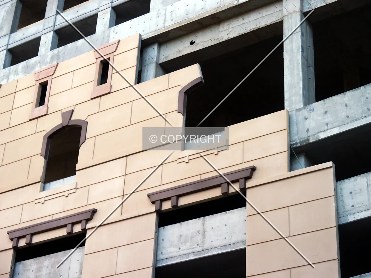 Section of the facade over the garage