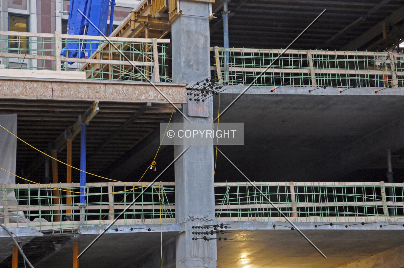 Exposed rebar and post-tensioning cables on the east side of the parking podium