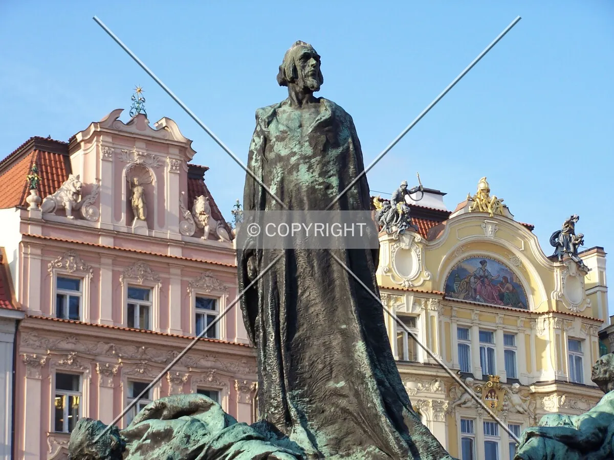 Statue in the Old Town Square with typical houses