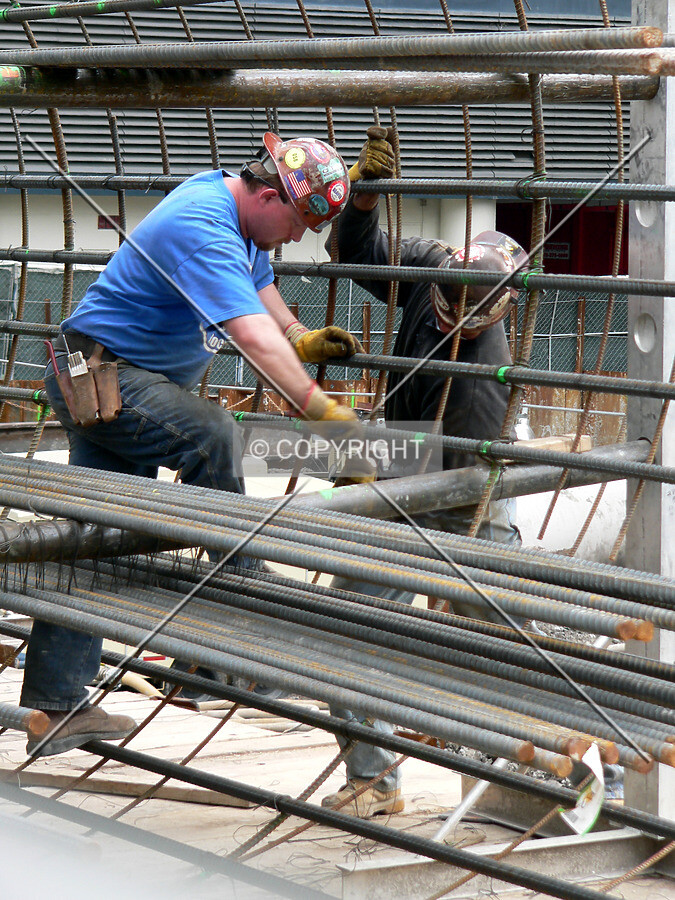 Workers assembling rebar cages