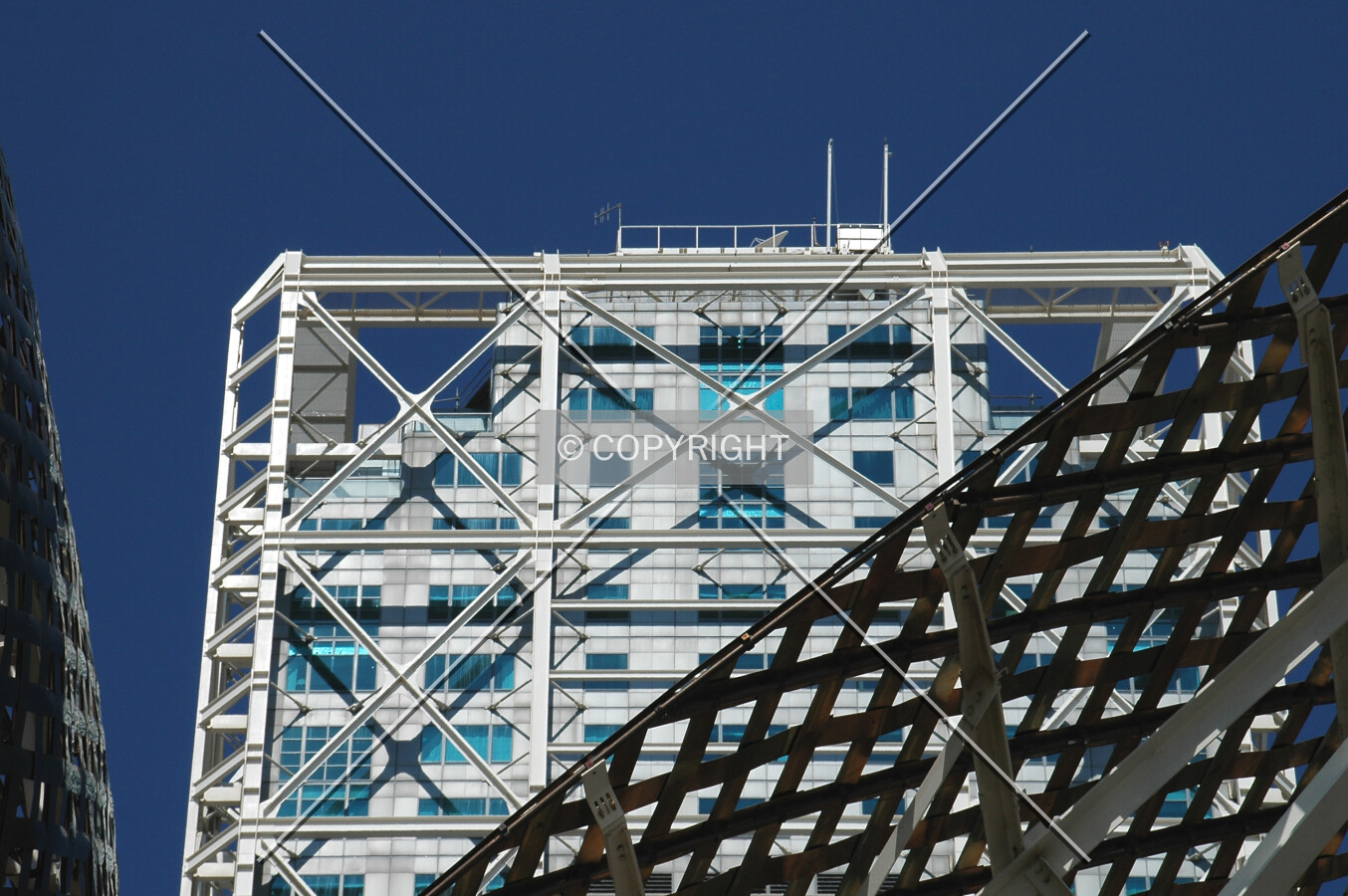 The top seen over the sculpture in front of the complex