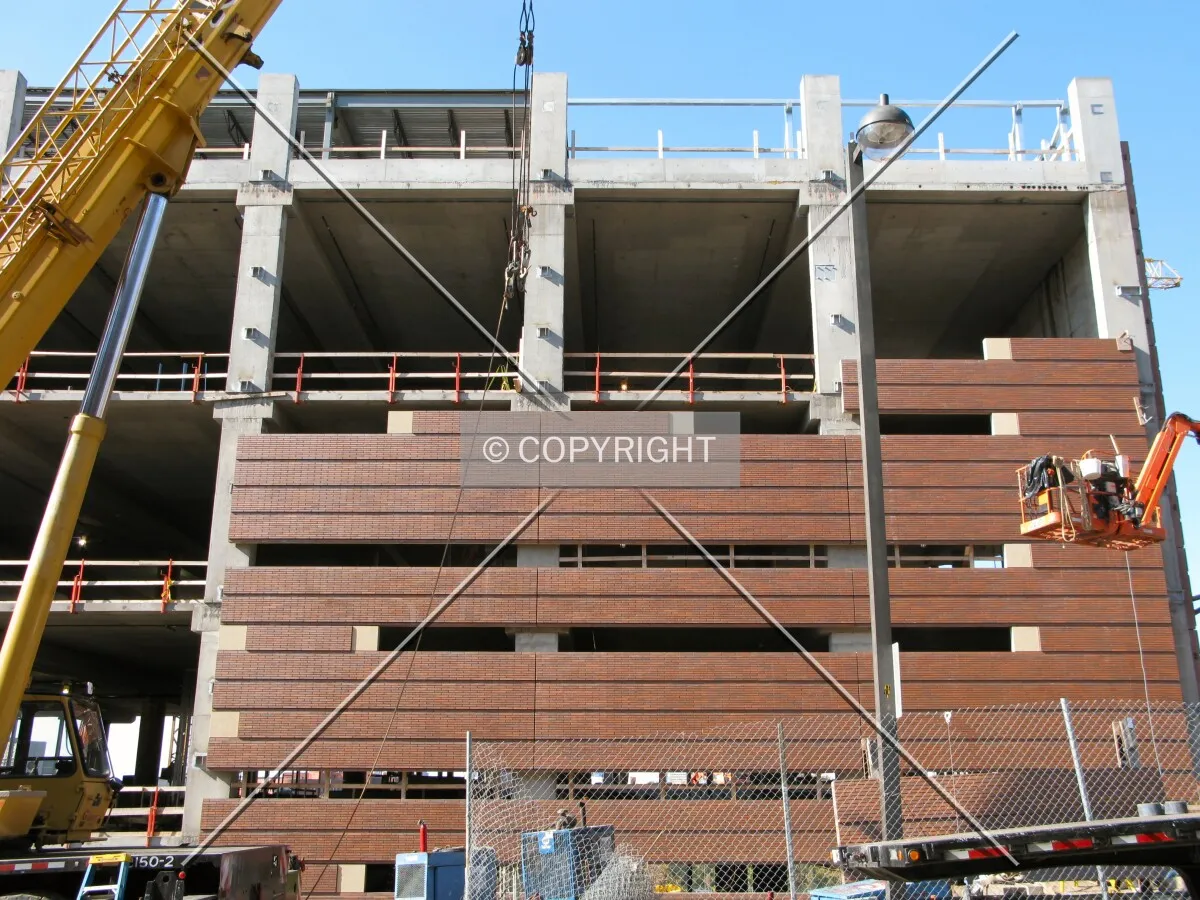 Partially-installed brick facade panels from Pleasant Street