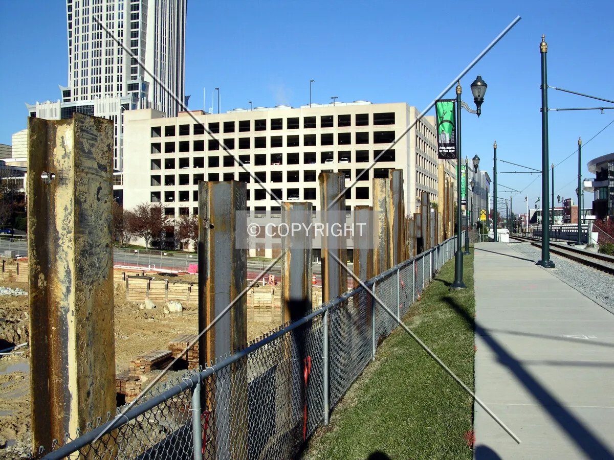 I-beam tops of the retaining wall built along the Charlotte Trolley Tracks to the east