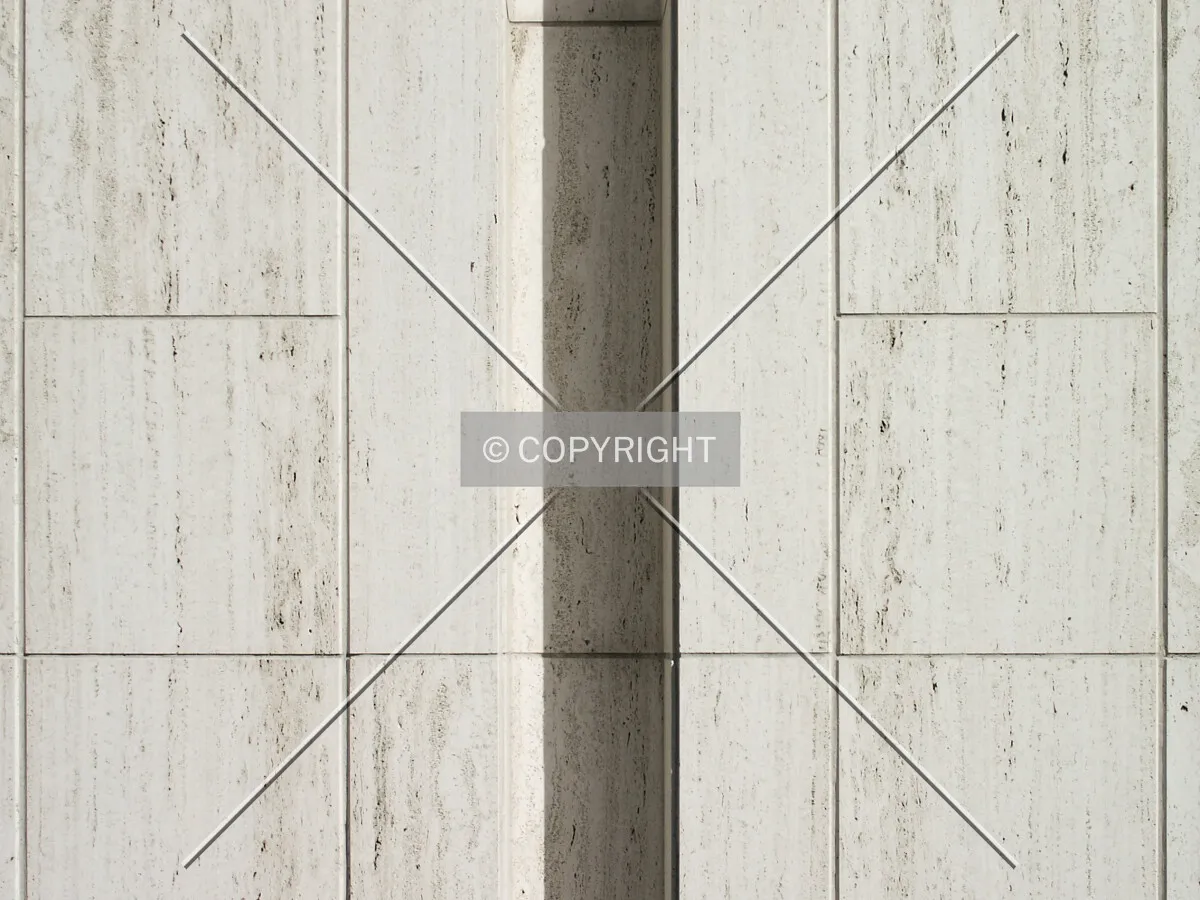 Section of the travertine facade near the entrance