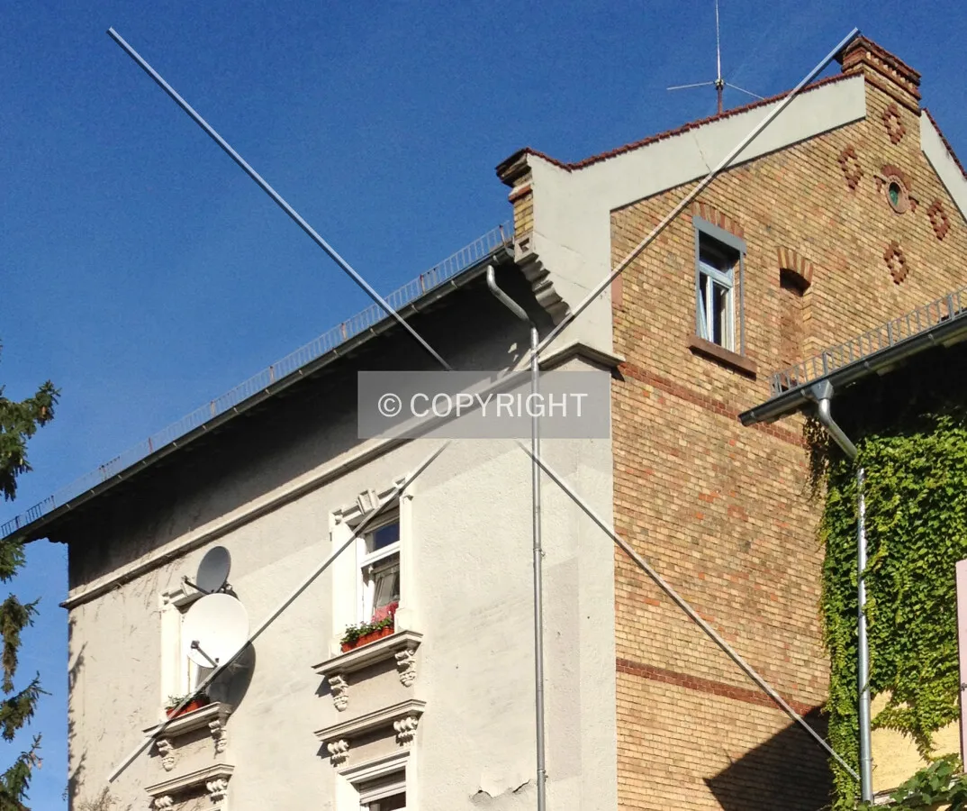 An old building featuring a masonry structural material (right) and a stucco facade (left)
